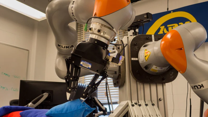 Inside the Autonomous Robotic Manipulation (ARM) Lab, massive KUKA robotic arms select and delicately transfer the correct beanbag from a pile of random objects. Photo: Robert Coelius