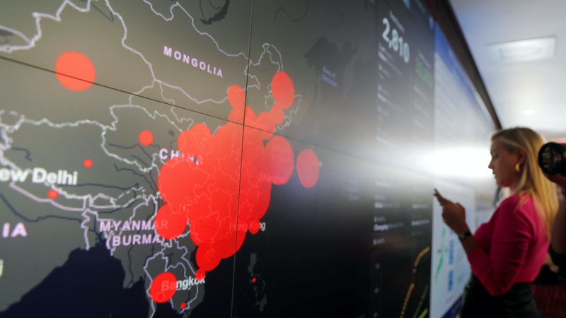 A Covid-19 taskforce examines a map of the virus’ spread. PHOTO CREDIT: Carlos Barria | Reuters