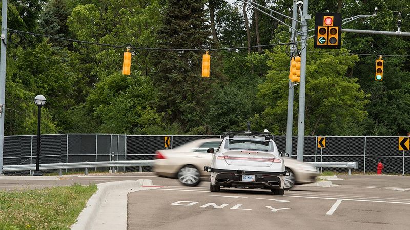 Even though it has the right of way, the connected and automated Lincoln MKZ stops at an intersection because another vehicle is running the light. Vehicle-to-vehicle communication enabled this safety feature. Photo by Michigan Photography