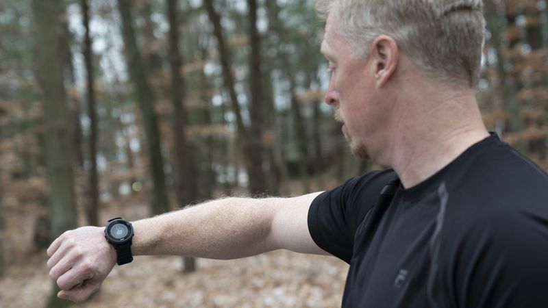 Lincoln Laboratory researcher James Balcius tests the heat strain detection device. The smartwatch displays a thumbs-up and green background, indicating that he is not at risk of heat injury at this time. Photo: Glen Cooper