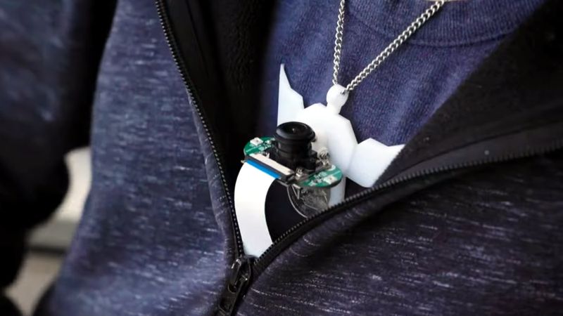 The SpeeChin prototype is worn around the neck to capture facial movements via an upwards-angled infrared camera.