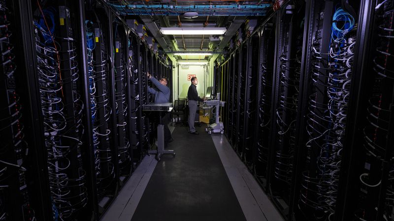 At the Lincoln Laboratory Supercomputing Center, researchers are making changes to cut down on energy use. One of their techniques can reduce the energy of training AI models by 80 percent. Photo: Glen Cooper