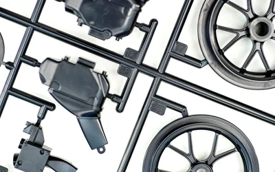 What are injection mold sprues, runners, and gates?