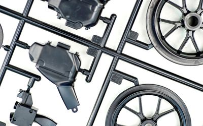What are injection mold sprues, runners, and gates?