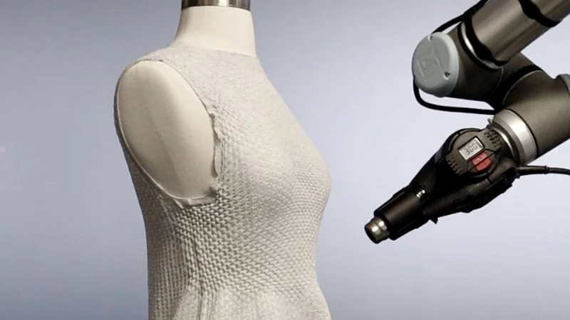 Caption:In late 2023 the MIT Self Assembly Lab and the high-tech fashion company Ministry of Supply debuted their 4D Knit Dress at the latter's store Boston, complete with a robotic arm working its way around a dress as customers watched. Credits:Image courtesy of MIT Self Assembly Lab