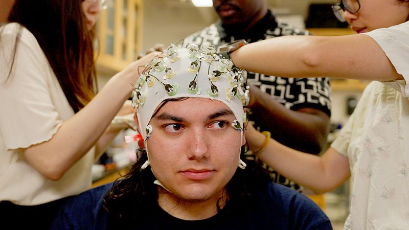 As part of a study of stress and the brain, researchers monitor electrical signals on a participant’s scalp using a swim cap studded with electrodes. Photo by Virgil Ward