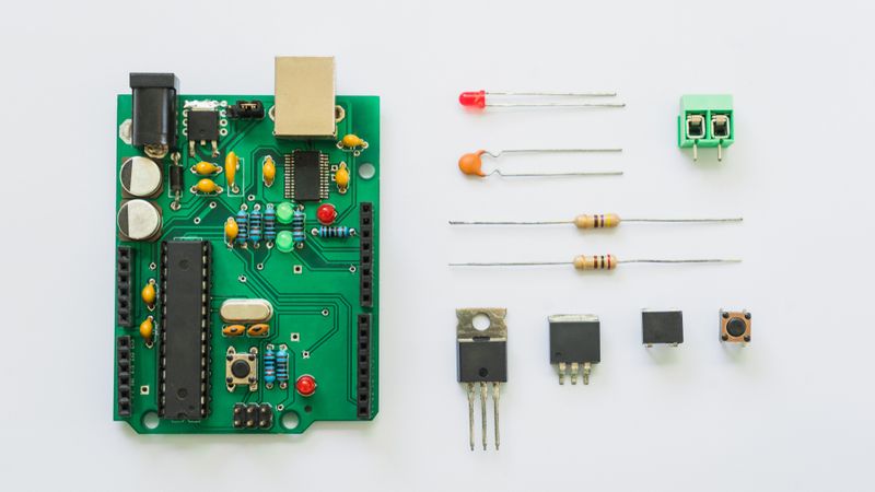 PCB Board with electronic components: Resistor, ICs, Capacitor, Switch, and Connector