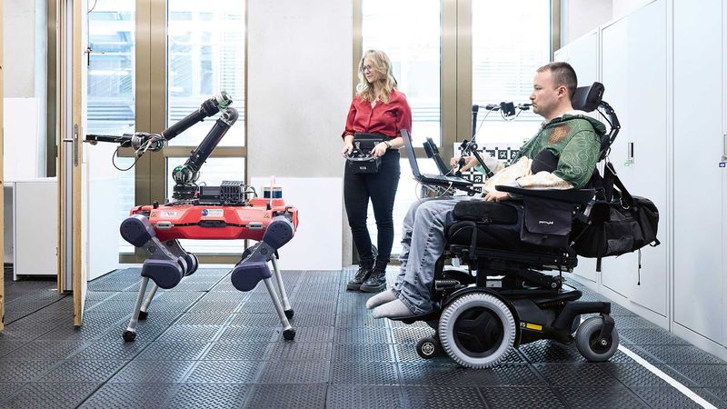 Helping to open doors: Cybathlon pilot Sammy Kunz uses his mouth to steer the assistance robot, while Carmen Scheidemann from the Robotics Systems Lab monitors the test run. Come October, the pressure will be on. (Photograph: Markus Bertschi / ETH Zurich)