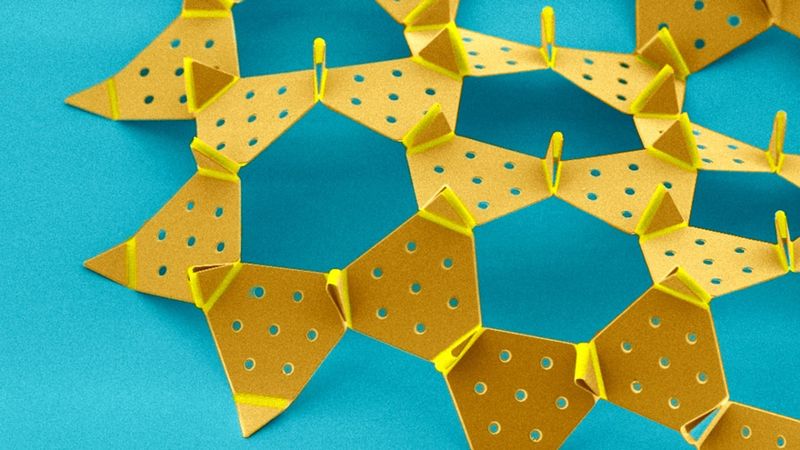 The kirigami robot is a hexagonal tiling composed of approximately 100 silicon dioxide panels that are connected through more than 200 actuating hinges.
