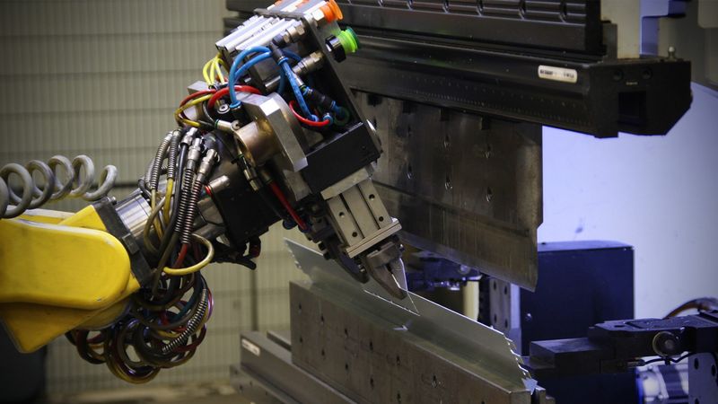 Close-up of the robot with the redesigned gripper in action