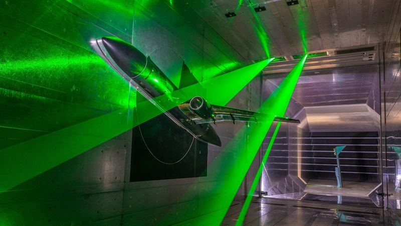 The NASA aircraft model inside the DNW Braunschweig Low-Speed Wind Tunnel (DNW-NWB). 'Sheets' of laser light illuminating the inner and outer wings are used to measure flow velocities. Credit: DLR (CC BY-NC-ND 3.0)