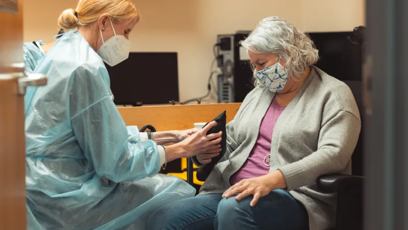 Postdoctoral researcher Caitlyn Seim takes measurements with a participant in the clinical trial. | Image courtesy of Andrew Brodhead